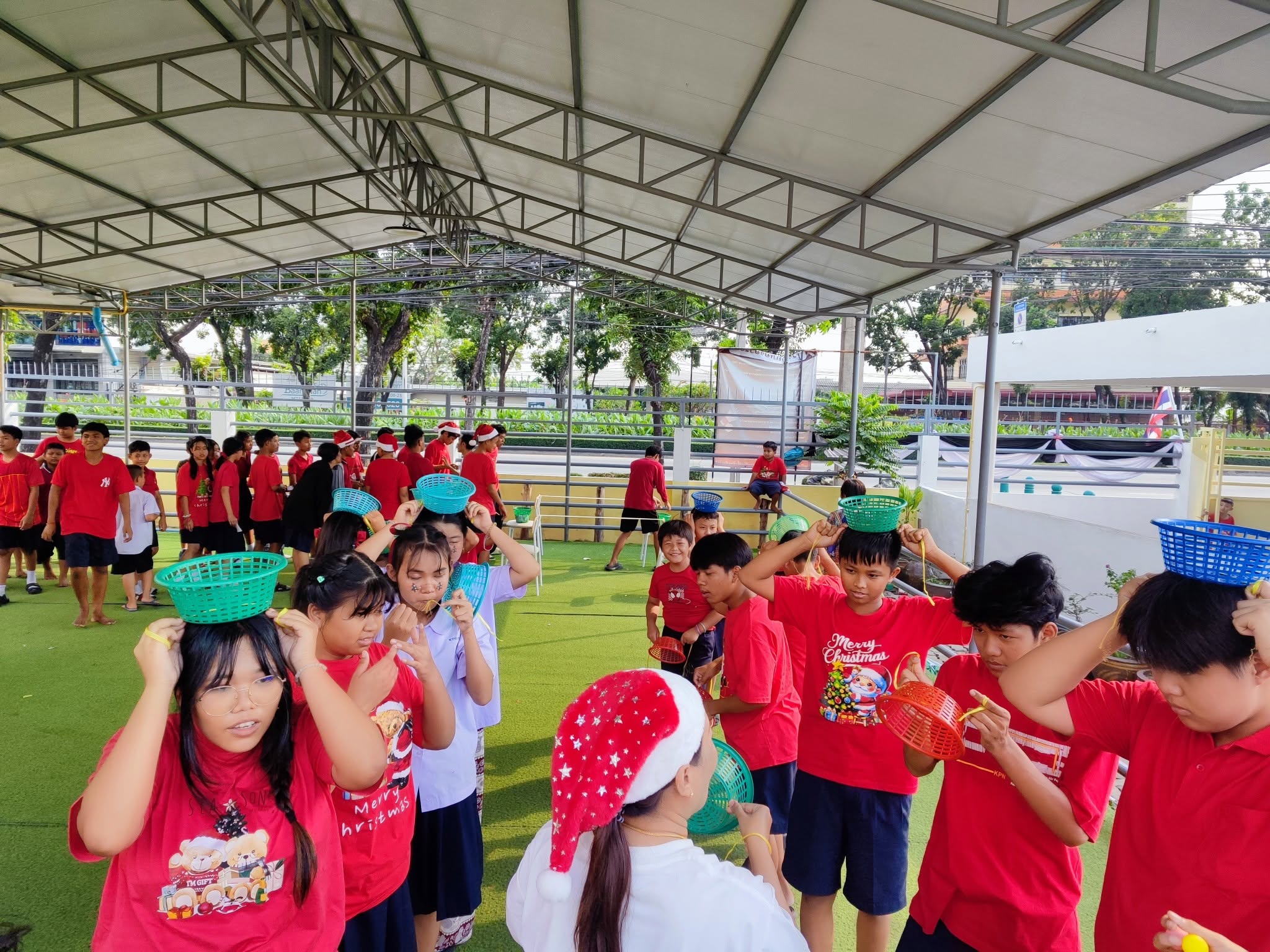 Kong Lah School students playing a basket game during a school celebration.